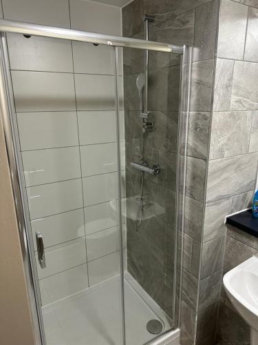 a shower with a glass door in a bathroom at Luxury Studio Apartment by Central Stay in Liverpool