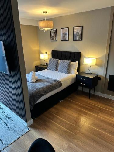 a bedroom with a large bed and two lamps at Luxury Studio Apartment by Central Stay in Liverpool