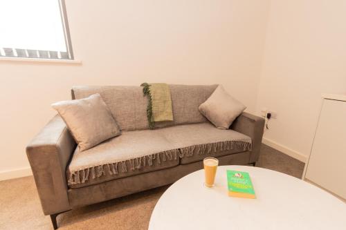 a living room with a couch and a table at Boutique 1BR Apartment in the heart of Preston in Preston