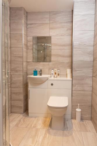 a bathroom with a toilet and a sink and a shower at Boutique 1BR Apartment in the heart of Preston in Preston