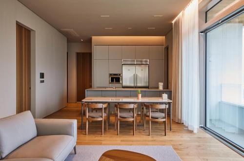 a kitchen with a table and chairs in a room at The Heaven Resort in Ansan