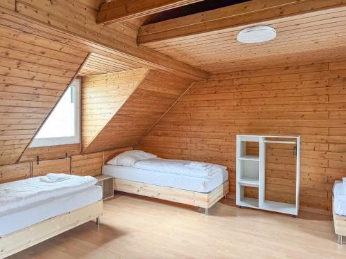 a bedroom with two beds in a wooden room at 6 room detached house - Köln Messe Fair 10min in Cologne