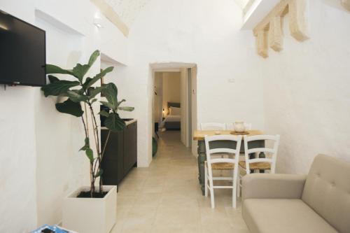 a living room with a couch and a table at Mediterranee Suite in Lecce