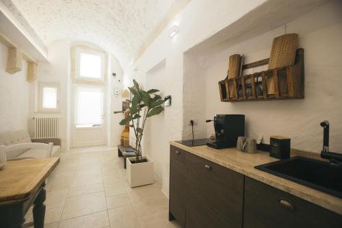 a kitchen with a sink and a counter top at Mediterranee Suite in Lecce
