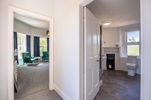 a hallway with a living room with a fireplace at Cosy Wolf Bed & Breakfast in Freshwater