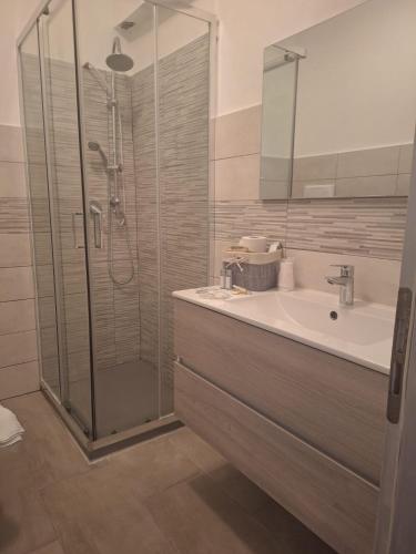 a bathroom with a glass shower and a sink at Hotel Antico Borgo in Riolo Terme