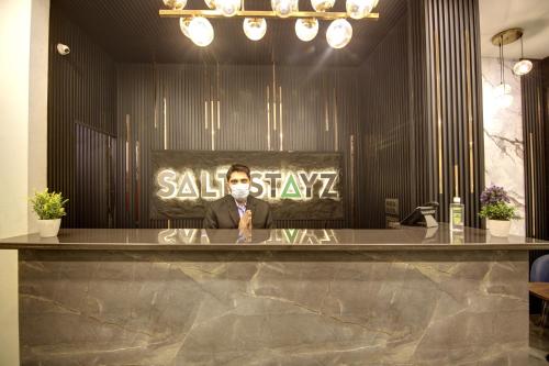a man sitting at a counter in a salon at Saltstayz Thyme - New Friends Colony in New Delhi