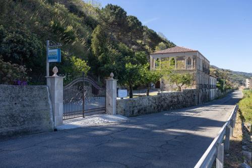 a gate on a road with a house on a hill at DIMORA LE PIETRE DEL MARE in Pizzo