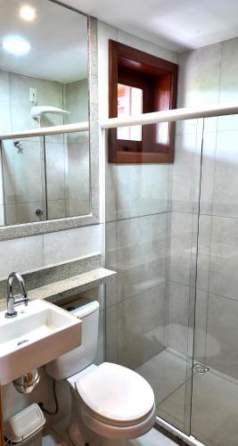 a bathroom with a toilet and a sink and a shower at Apt 3 Quartos em Condo de Luxo in Mata de Sao Joao