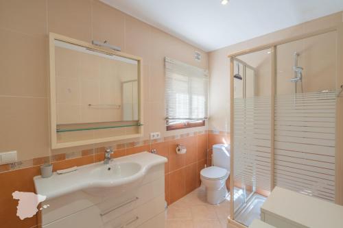 a bathroom with a sink and a toilet and a mirror at CostaBlancaDreams Casa Narciso in Calpe in Empedrola