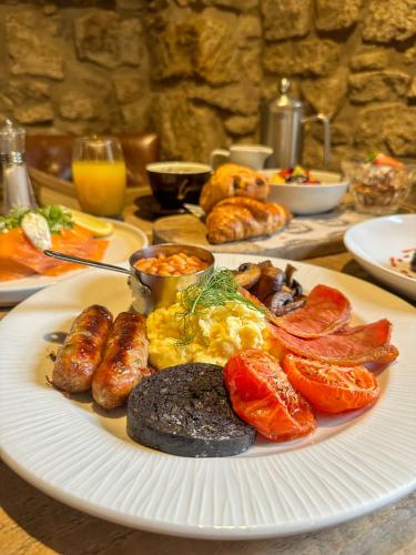 a plate of breakfast food on a table at The Northumberland Arms in West Thirston
