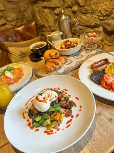 a table with plates of food on a table at The Northumberland Arms in West Thirston