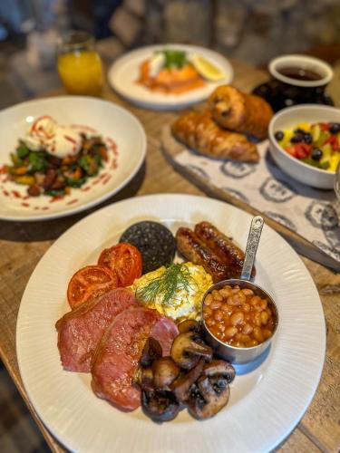 a wooden table with plates of food on it at The Northumberland Arms in West Thirston