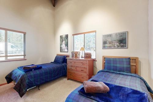 a bedroom with two beds and a wooden dresser at Home in the Pines in Munds Park