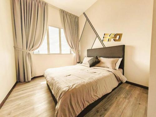 a bedroom with a bed and a large window at Stylish Apartment and Cozy Feel in Kuching