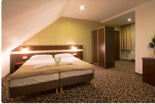 a bedroom with a large bed in a room at Pivovar Sandorf in Prievaly