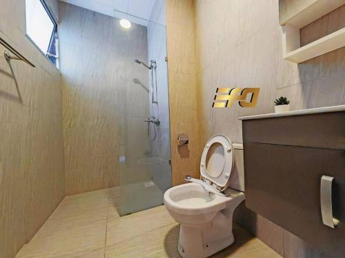 a bathroom with a toilet and a shower at Stylish Apartment and Cozy Feel in Kuching