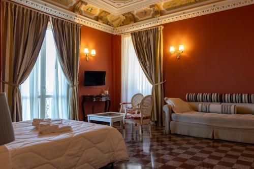 a hotel room with a bed and a couch at DIMORA LE PIETRE DEL MARE in Pizzo