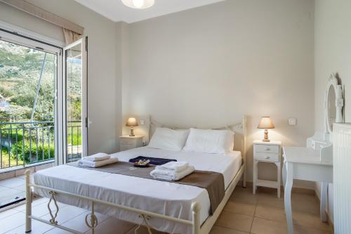 Postel nebo postele na pokoji v ubytování Villa Giorgio Palairos