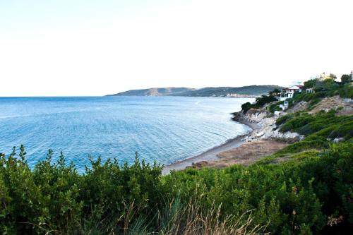 a view of a beach with houses and the ocean at Sea Breeze Apartments Chios in Monolia