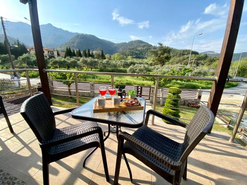 a table and chairs on a balcony with a view at Aelia Studios in Skala Potamias