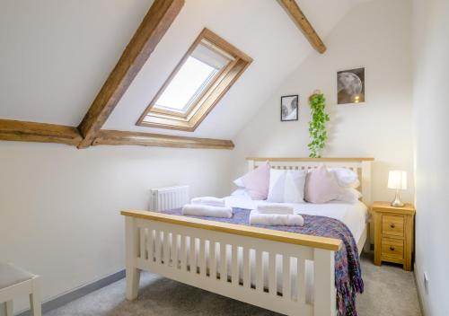 a bedroom with a bed and a window at Llysfaen Cottage in Cray