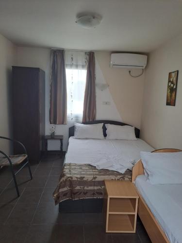 a hotel room with two beds and a window at Casa Ancuta in Eforie Sud