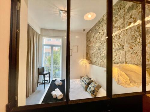 a mirror in a room with a bed in it at Elegant Bel Epoque Apartment In Center Of Menton in Menton