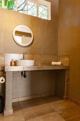 a bathroom with a sink and a mirror at Waters on Willows in Pretoria