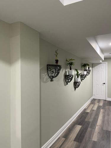 a hallway with potted plants on the wall at Niagara Falls BNB 15 mins away from Falls in Thorold