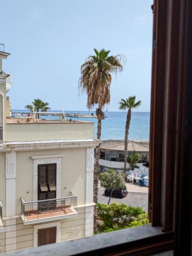 a view from a window of a building and a palm tree at Gemma del mare in Crotone