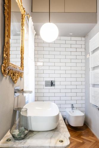 a bathroom with a large white tub and a sink at San Giuseppe apartment con Terrazza in Siracusa