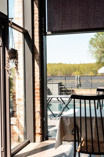 an open glass door to a patio with a view of the water at RESIDENCE BACO Da SETA in Mestre