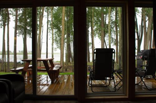 a view of a screened in porch with a table and chairs at Sunrise Shore in Au Gres