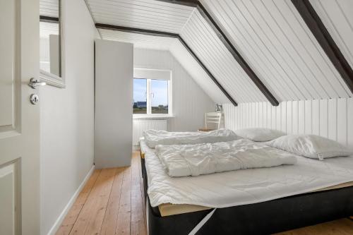 a bedroom with two beds in a attic at Pool house with beautiful view by the sea - SJ650 in Lemvig