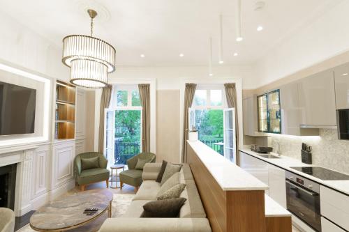 a living room with a couch and a table at Holland Park Residence in London