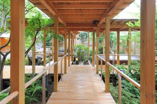 a wooden walkway in a garden at Yuzawa Grand Hotel in Yuzawa