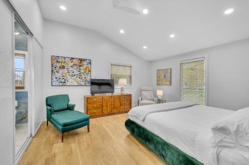 a bedroom with a bed and a tv and a chair at The Lakehouse in Hendersonville