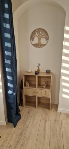 a room with a wooden table and a picture on the wall at Némo Petit studio cosy. in Orville
