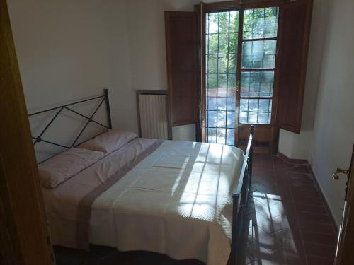 ポンテデーラにあるPodere Travalda - appartamento in agriturismo per 4-6 personeのベッドルーム1室(ベッド1台、窓2つ付)
