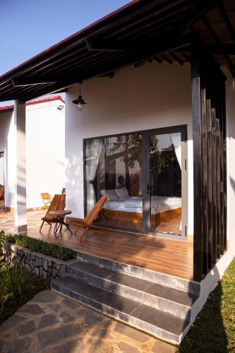 a home with a wooden deck with a patio at Bảo Lộc Home in Bao Loc