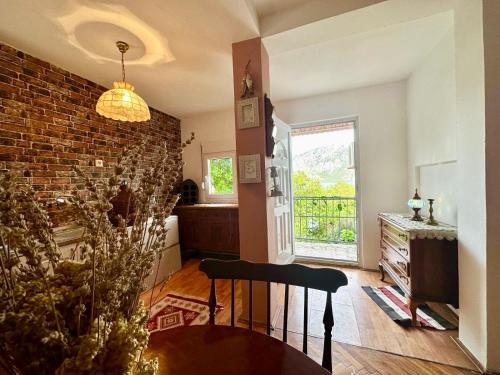 a living room with a staircase and a brick wall at Villa Terrazza in Donji Morinj