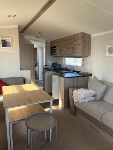 ein Wohnzimmer mit einem Sofa und einem Tisch in der Unterkunft Saltsea in Padstow