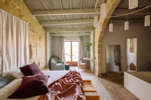 a living room with a large bed and a couch at Amagatay Luxury Boutique Hotel - Adults Only in Alaior