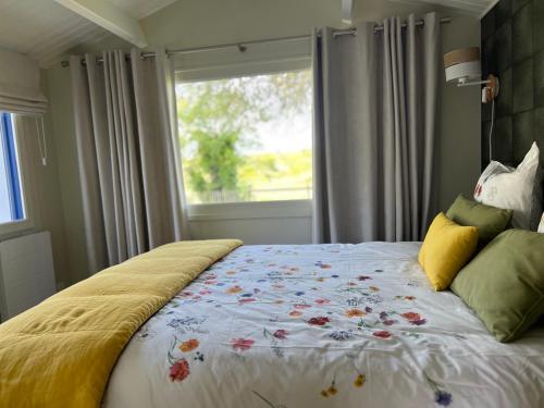 a bedroom with a large bed with a window at Gîtes de charme "l'écrin de Vendée" 10 mn des plages, piscine du domaine, et ses 2 Maisons avec chacune leur spa privatif in Sallertaine