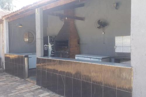 an outside view of a kitchen with a counter top at Casa espaçosa, piscina, churrasqueira , area festa in Corumbá