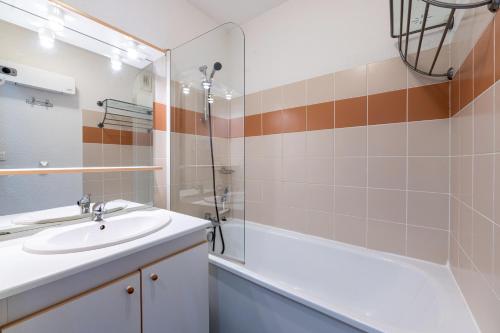 a bathroom with a sink and a shower at Appartement St François Longchamp in Saint-François-Longchamp