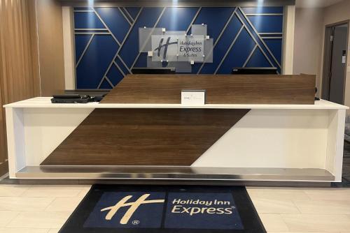 a display case in a store with wood at Holiday Inn Express & Suites Huntsville by IHG in Huntsville