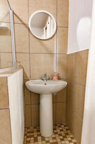 a bathroom with a sink and a mirror at Waters on Willows in Pretoria