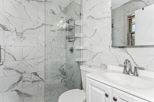 a white bathroom with a toilet and a sink at 2967 Swan Lane in Pensacola